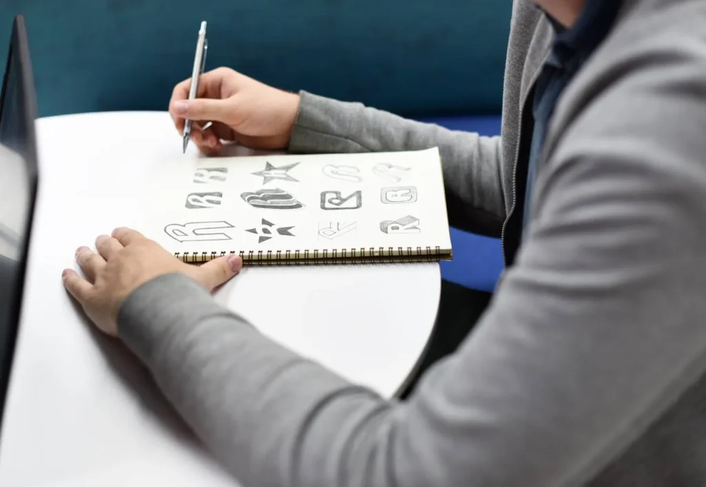Designer sketching custom logo concepts for branding