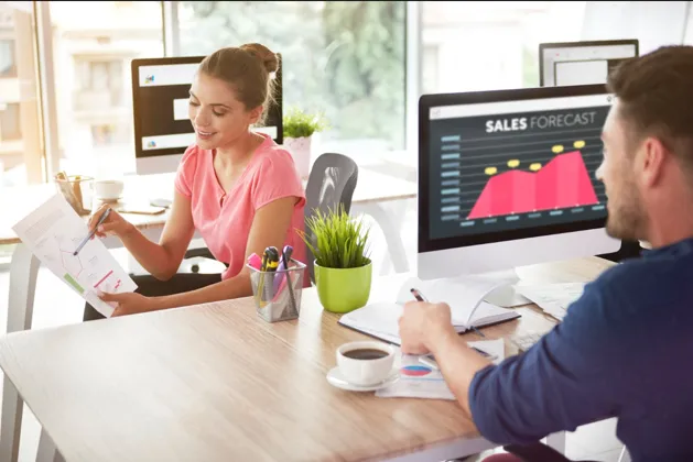 Business professionals analyzing sales performance and reports
