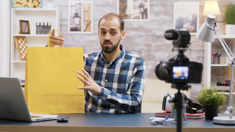 Content creator presenting a product during a promotional video recording