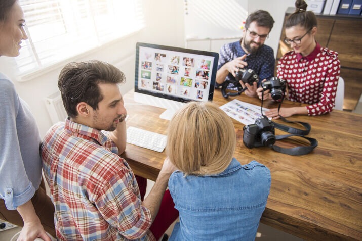 Creative team reviewing visual content and planning video production